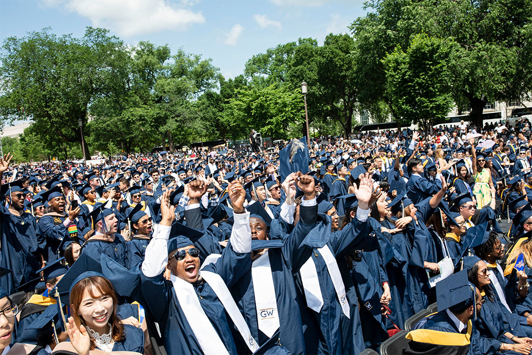 Students Cheering in seats at Commencement 
